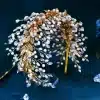 Left view of Braidani gold pearl crystal wedding hair accessories headband, showcasing elegant pearls and crystals, perfect for enhancing bridal hairstyles.