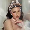 Model wearing Braidani gold pearl crystal wedding hair accessories headband, showcasing its elegant design and perfect fit for bridal hairstyles.