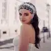 Model wearing Braidani silver pearl crystal wedding hair accessories headband, showcasing its elegant design and fit for bridal hairstyles.