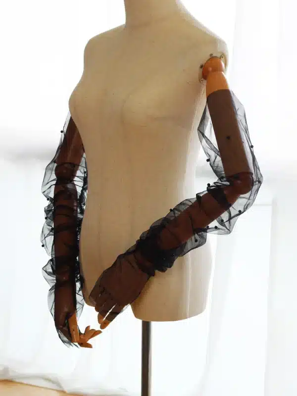 Model wearing Braidani Black lace Gloves – Elegant opera-length gloves with pearl embellishments, perfect for weddings and formal events.